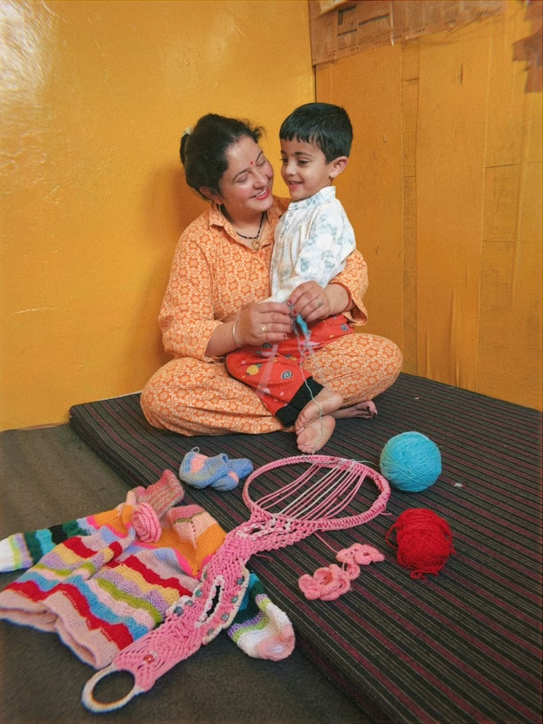 Mother crocheting with her child